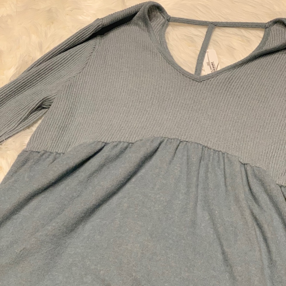 Long sleeve, light blue sweater material blouse.